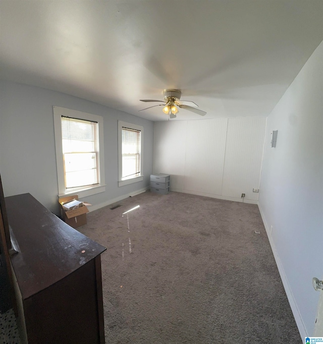 empty room featuring carpet and ceiling fan