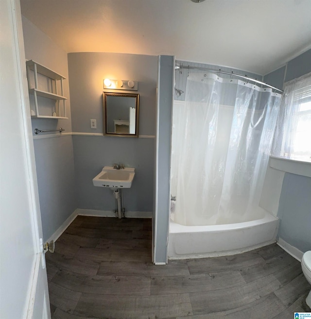 full bathroom with sink, shower / tub combo, hardwood / wood-style flooring, and toilet