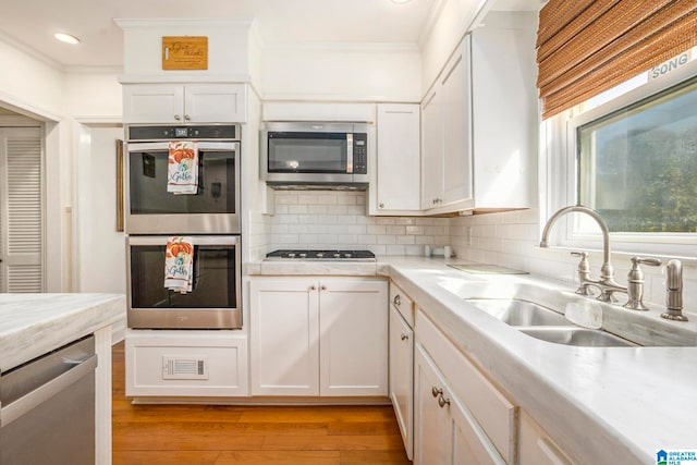 kitchen featuring white cabinets, sink, and stainless steel appliances