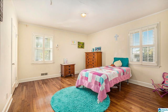 bedroom featuring ornamental molding and hardwood / wood-style floors