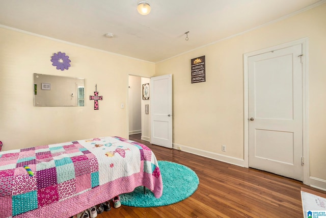 bedroom with crown molding and hardwood / wood-style flooring