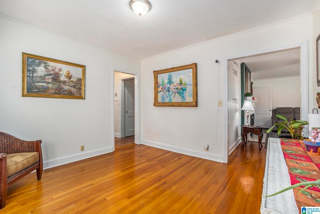 living area featuring ornamental molding and wood-type flooring