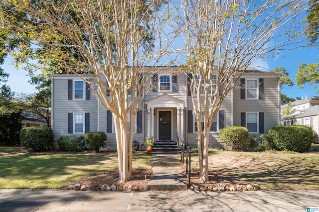 colonial inspired home with a front yard