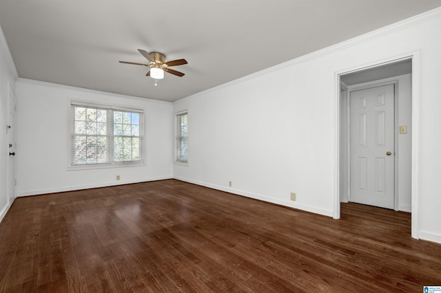 spare room with dark wood-type flooring, crown molding, and ceiling fan