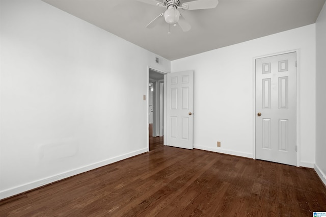 unfurnished bedroom featuring dark wood-type flooring and ceiling fan