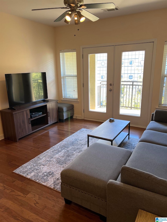 living room with french doors, ceiling fan, and dark hardwood / wood-style floors