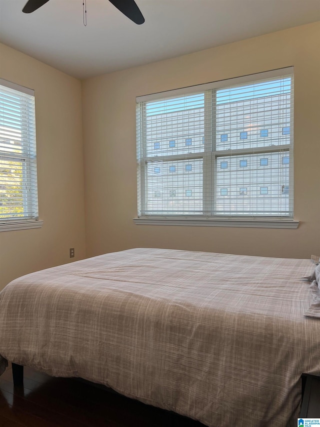 bedroom with wood-type flooring and ceiling fan