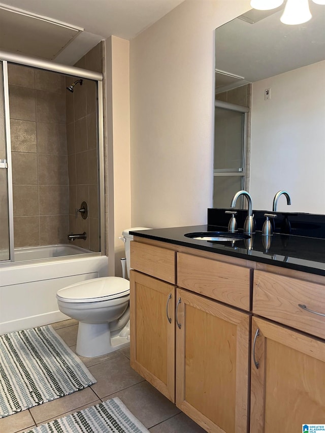 full bathroom featuring vanity, tiled shower / bath combo, toilet, and tile patterned flooring