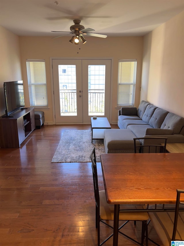 living room featuring french doors, dark wood-type flooring, and ceiling fan