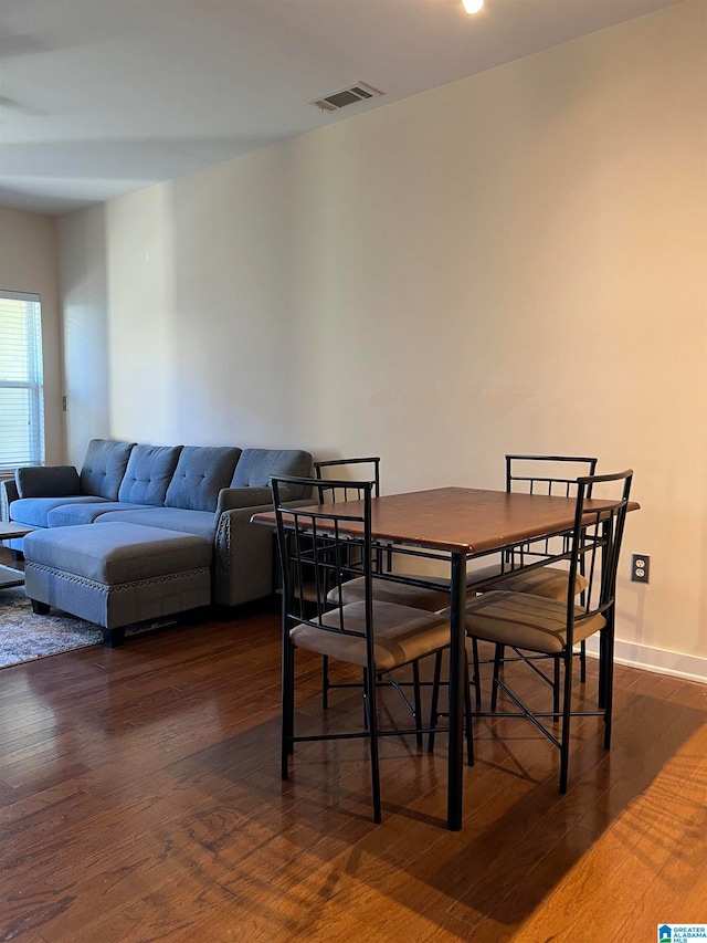 dining area featuring dark hardwood / wood-style floors