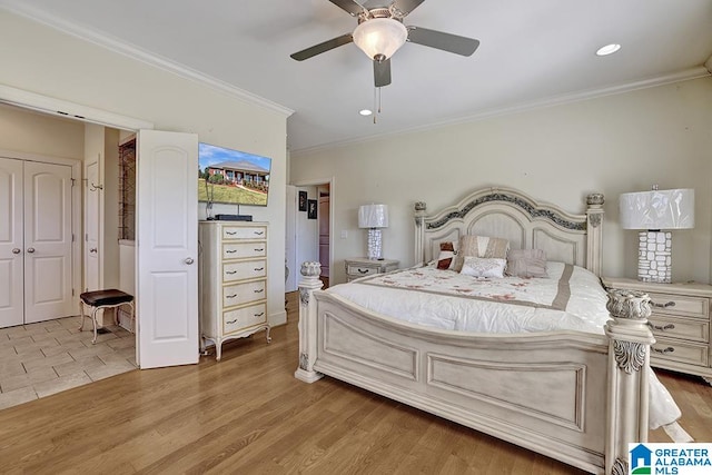 bedroom with ceiling fan, light hardwood / wood-style flooring, and ornamental molding