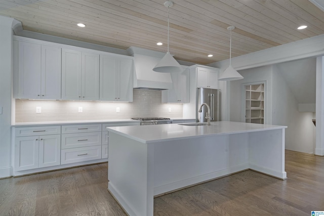 kitchen featuring a center island with sink, light countertops, wood ceiling, custom range hood, and a sink