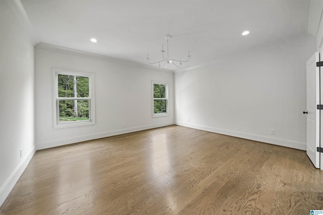 empty room with baseboards, ornamental molding, visible vents, and a chandelier