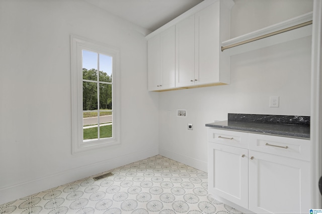clothes washing area featuring plenty of natural light, baseboards, hookup for an electric dryer, and visible vents