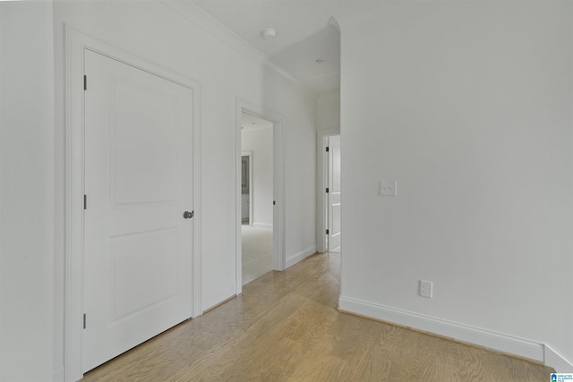 empty room with light wood-style floors and baseboards