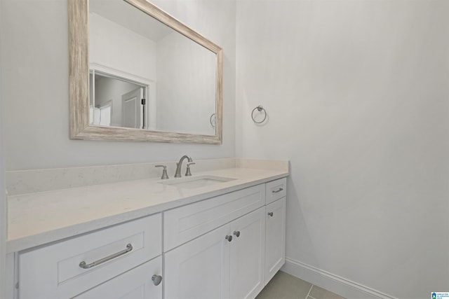 bathroom featuring tile patterned floors, baseboards, and vanity