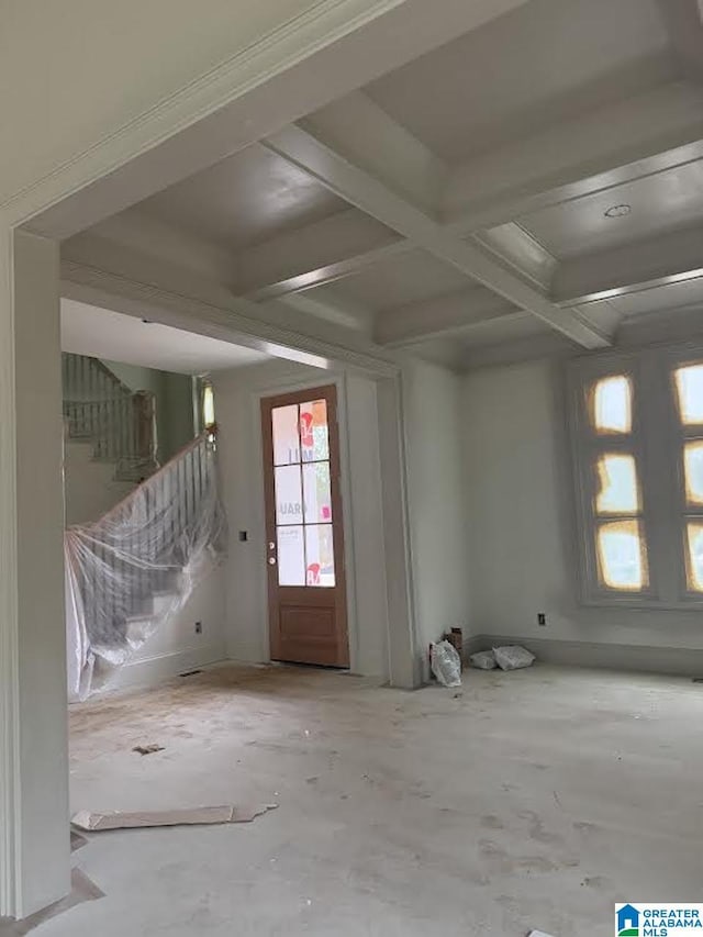 interior space featuring beamed ceiling, concrete floors, and coffered ceiling