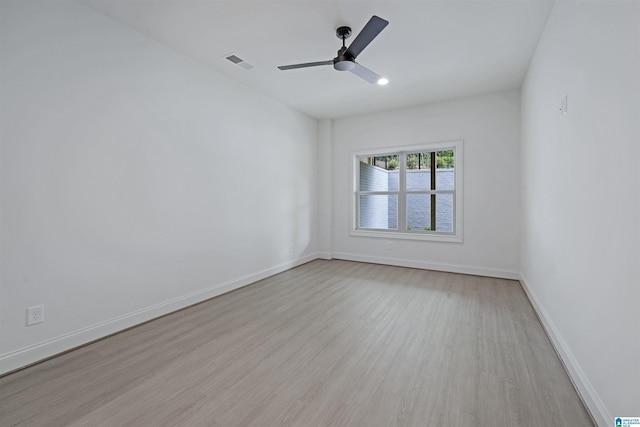 unfurnished room with a ceiling fan, baseboards, visible vents, and wood finished floors