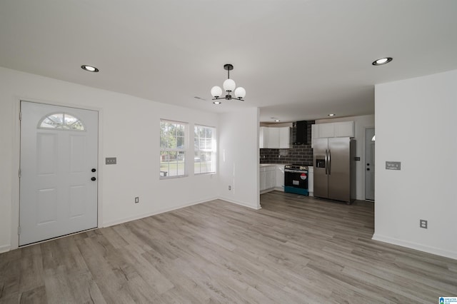 foyer featuring a notable chandelier and light hardwood / wood-style flooring