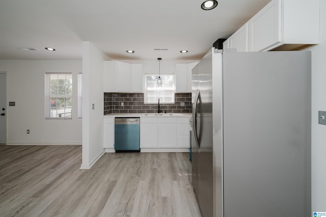 kitchen with sink, stainless steel appliances, light hardwood / wood-style floors, and plenty of natural light