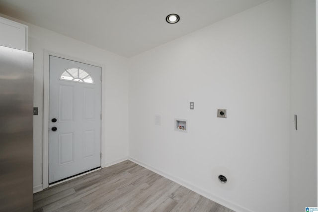 laundry area with hookup for an electric dryer, elevator, washer hookup, and light hardwood / wood-style floors