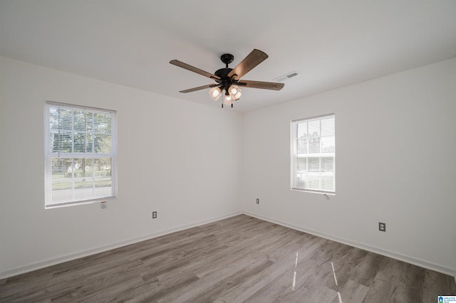 empty room featuring light hardwood / wood-style flooring and ceiling fan