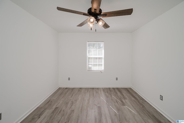 spare room featuring light hardwood / wood-style flooring and ceiling fan