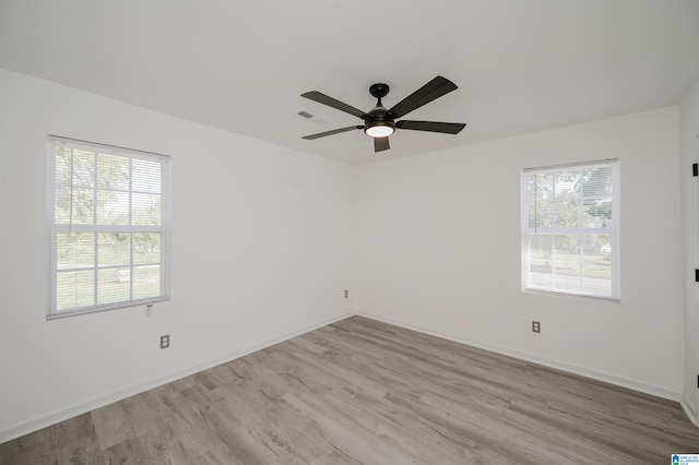 empty room featuring light wood-type flooring and ceiling fan