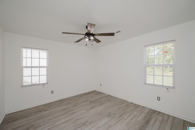 spare room with ceiling fan and light hardwood / wood-style flooring