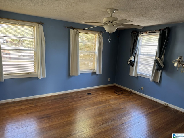 unfurnished room featuring ceiling fan, a textured ceiling, and dark hardwood / wood-style flooring