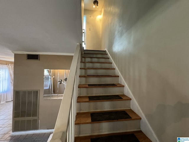 staircase with crown molding