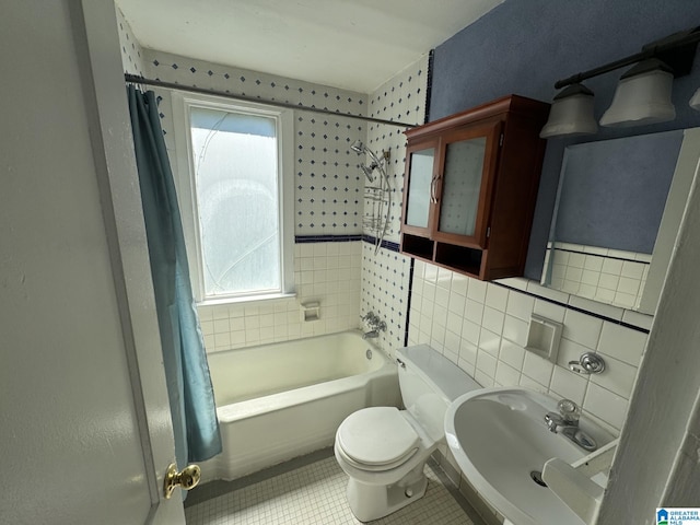 full bathroom featuring tasteful backsplash, toilet, shower / bath combo, sink, and tile patterned floors