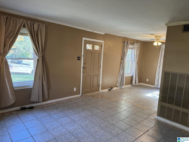 entryway featuring ceiling fan, ornamental molding, and light tile patterned floors