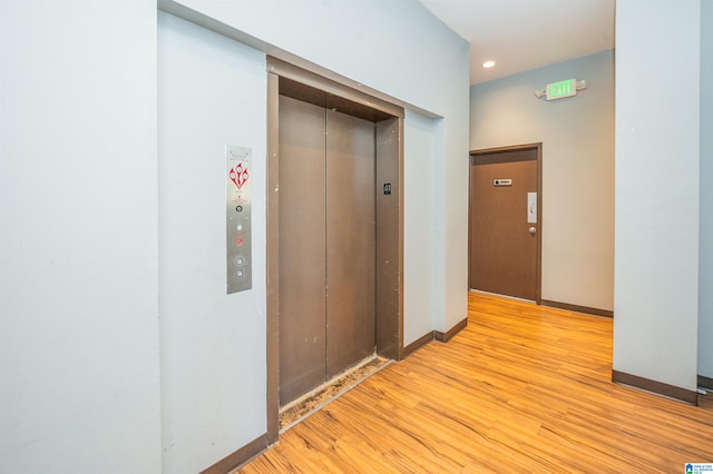 hall featuring light hardwood / wood-style floors and elevator