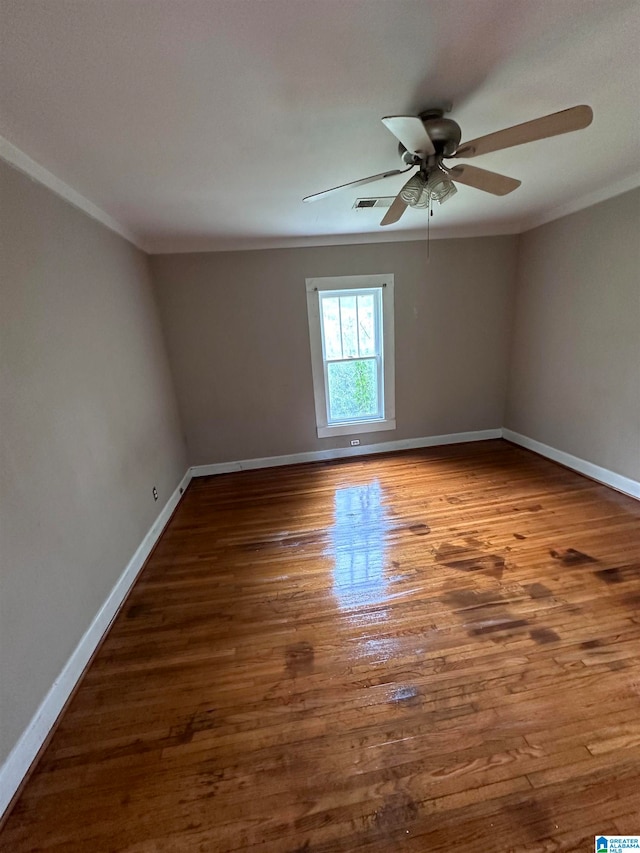 unfurnished room featuring ceiling fan, ornamental molding, and dark hardwood / wood-style floors