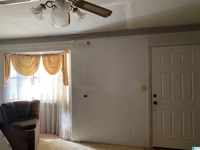 entrance foyer featuring light colored carpet and ceiling fan