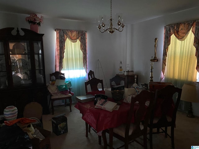 carpeted dining room with an inviting chandelier