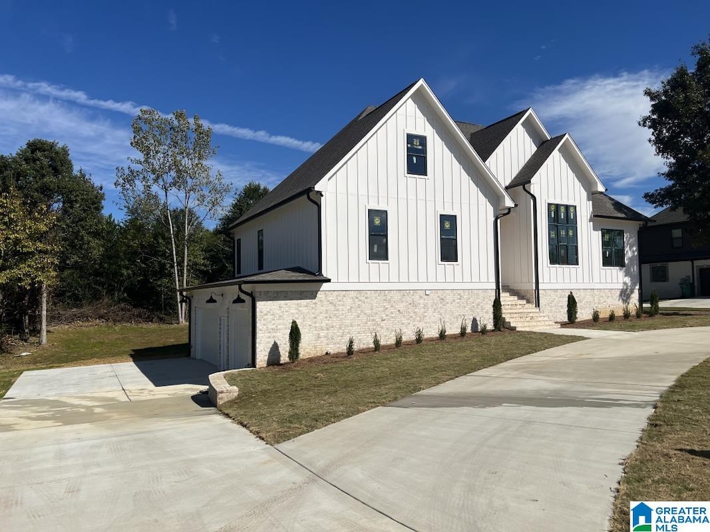 modern farmhouse style home with a garage and a front yard