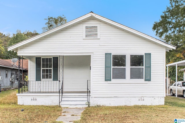 bungalow-style home featuring a front yard