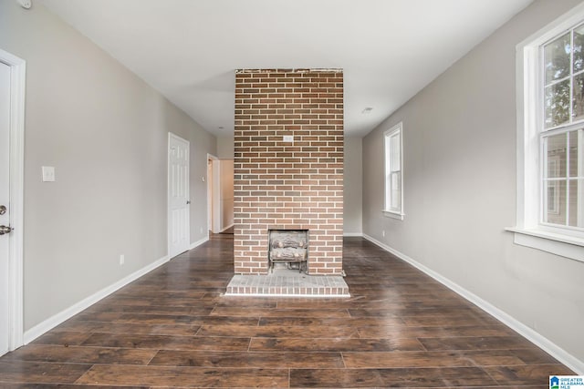 unfurnished living room with dark wood-type flooring