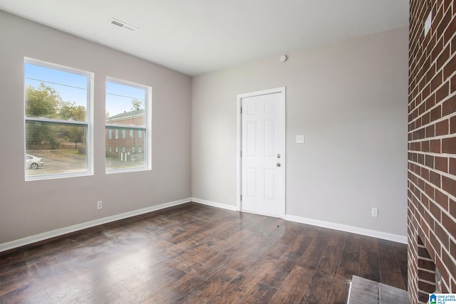 spare room featuring dark hardwood / wood-style floors