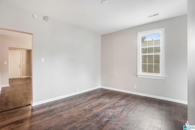 spare room featuring dark hardwood / wood-style flooring