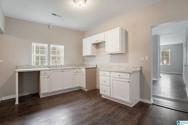 kitchen with sink, white cabinets, and dark hardwood / wood-style flooring