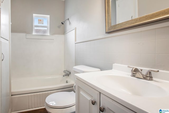 full bathroom with toilet, shower / washtub combination, vanity, and tile walls