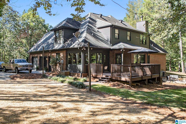 back of property with a wooden deck