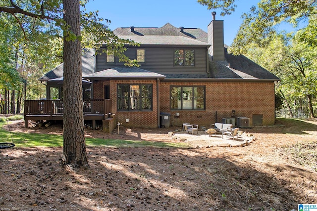 rear view of house featuring a patio and a deck