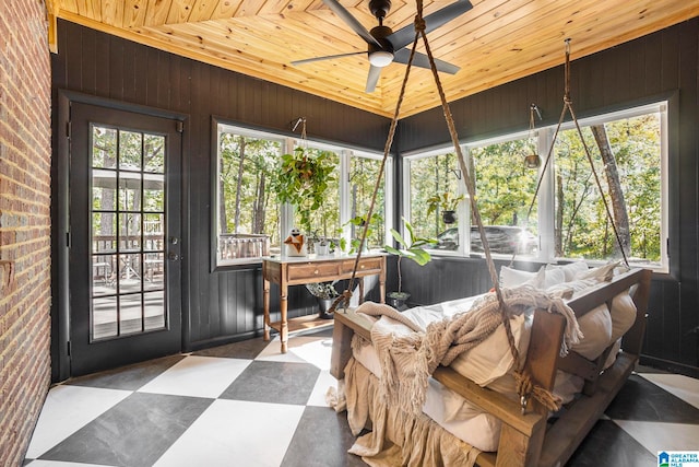 sunroom featuring wood ceiling and ceiling fan