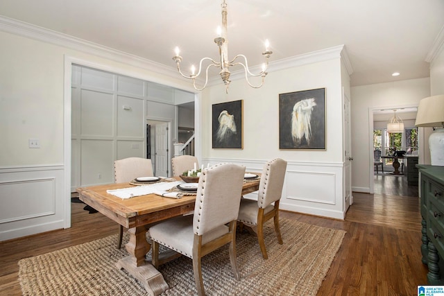 dining area featuring an inviting chandelier, ornamental molding, and dark hardwood / wood-style flooring