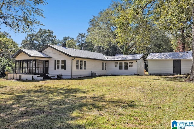 back of house with a yard, cooling unit, and a sunroom