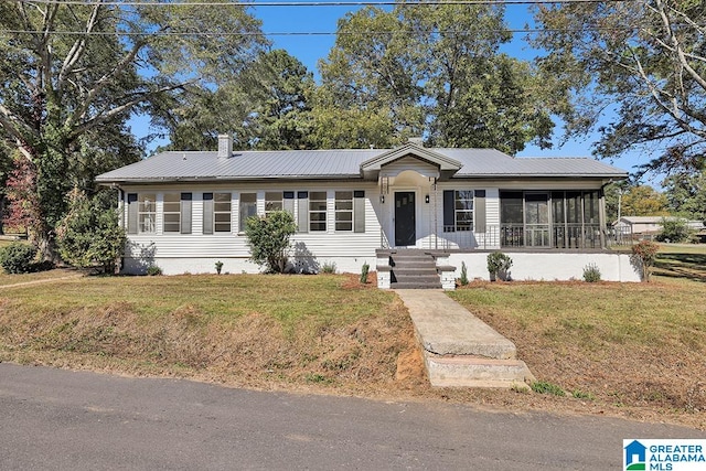 ranch-style home featuring a front lawn and a sunroom